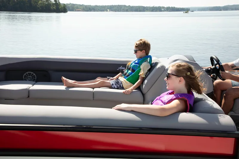 Slide: The Image of 2025 Barletta Aria 24UC pontoon boat with passengers relaxing on a sunny day. - 5