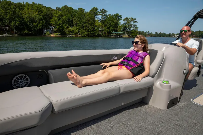 Slide: The Image of 2025 Barletta Aria 24UC pontoon boat with passengers relaxing on a sunny day. - 7