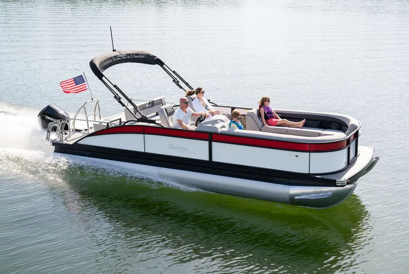 Slide: The Image of 2025 Barletta Aria 24UC pontoon boat cruising on a lake with passengers. - 8
