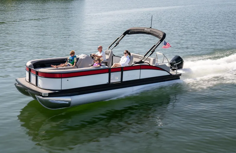 Slide: The Image of 2025 Barletta Aria 24UC pontoon boat cruising on a lake with passengers. - 9