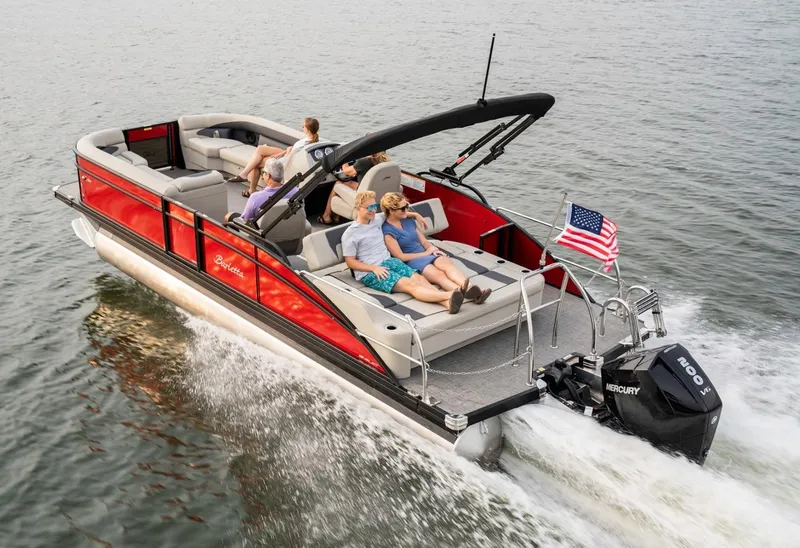 Slide: The Image of 2025 Barletta Aria 24UC pontoon boat cruising on water with passengers relaxing. - 4