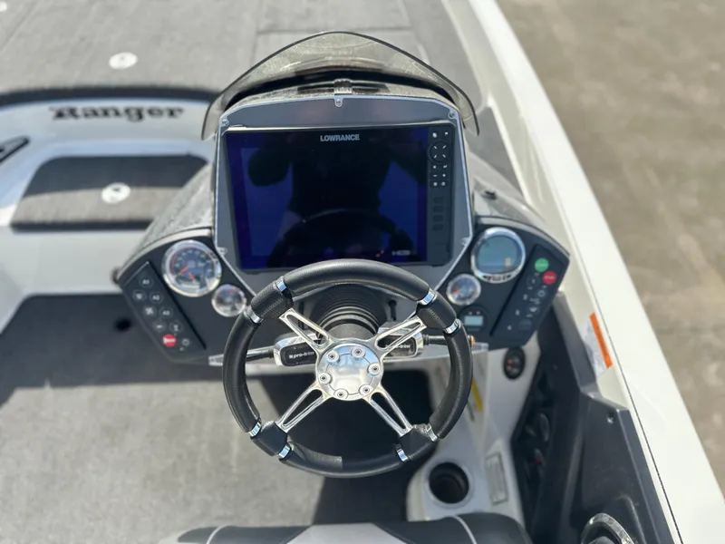 Slide: The Image of 2021 Ranger Z520C boat dashboard with steering wheel and Lowrance display. - 5