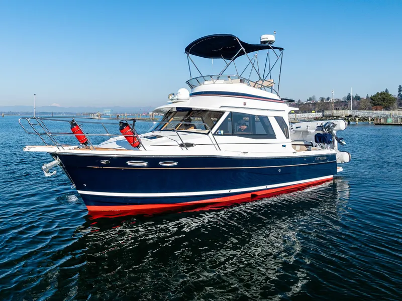 The Image of 2016 Cutwater 30 Command Bridge boat on calm water, featuring a sleek design and vibrant colors. - 0
