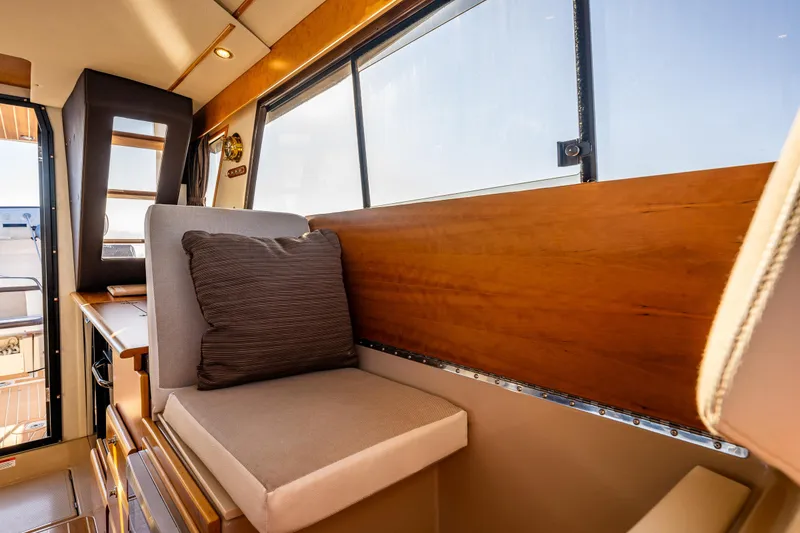 Slide: The Image of Interior of 2016 Cutwater 30 Command Bridge, featuring cushioned seating and wooden accents. - 20