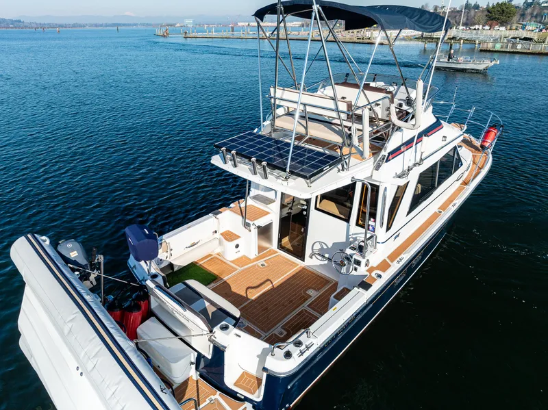 Slide: The Image of 2016 Cutwater 30 Command Bridge boat on water, featuring spacious deck and modern design. - 3