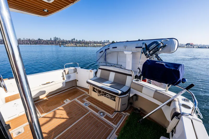 Slide: The Image of 2016 Cutwater 30 Command Bridge boat with spacious deck and seating, docked on calm water. - 7