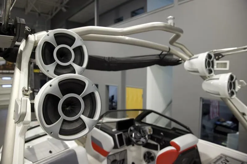 Slide: The Image of 2021 Malibu 25 LSV boat with premium audio speakers and modern interior design. - 10