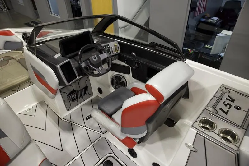 Slide: The Image of 2021 Malibu 25 LSV boat interior with modern dashboard and seating. - 11