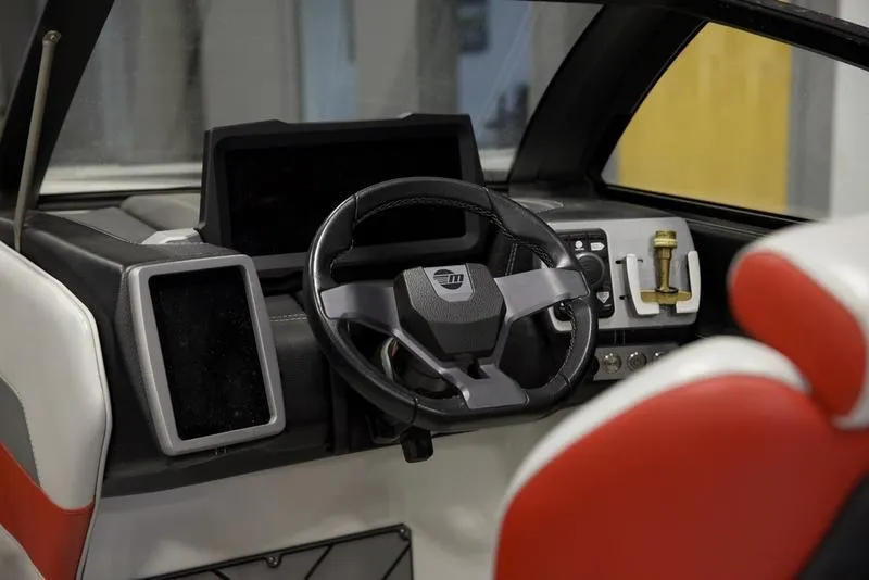 Slide: The Image of 2021 Malibu 25 LSV boat interior with modern steering and control panel. - 12