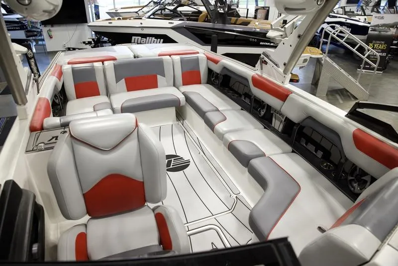 Slide: The Image of 2021 Malibu 25 LSV boat interior with red and gray seating, showcasing luxury design. - 17