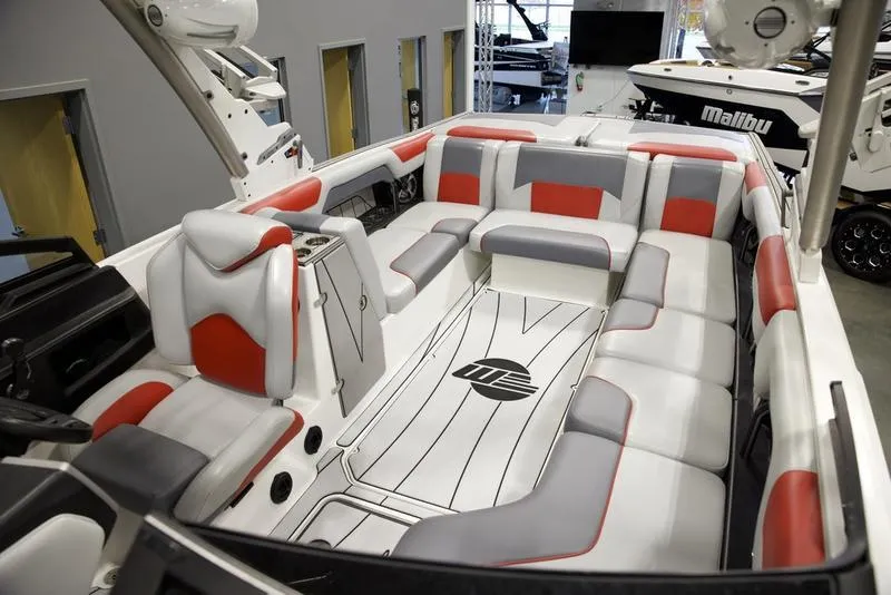 Slide: The Image of 2021 Malibu 25 LSV boat interior with red and gray seating, modern design. - 3