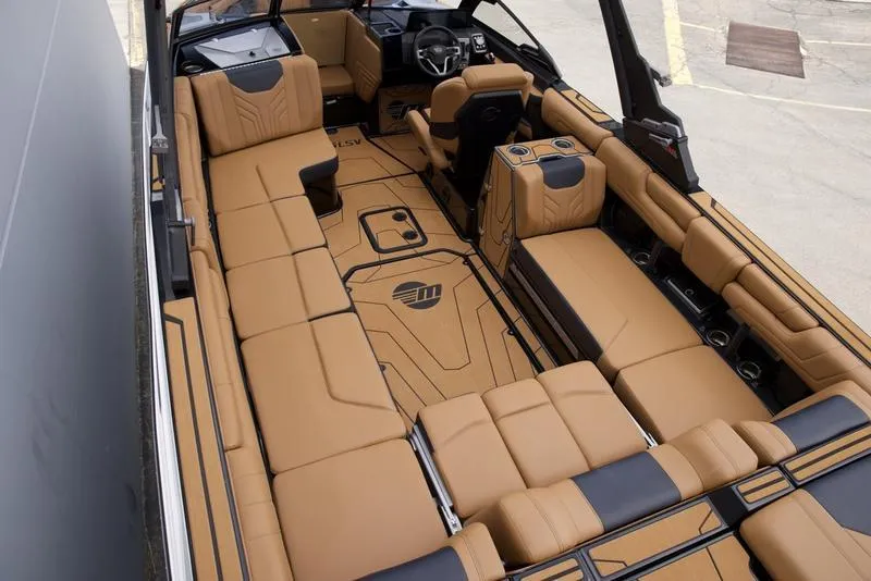 Slide: The Image of 2025 Malibu 25 LSV boat interior with luxurious tan seating and modern design. - 10