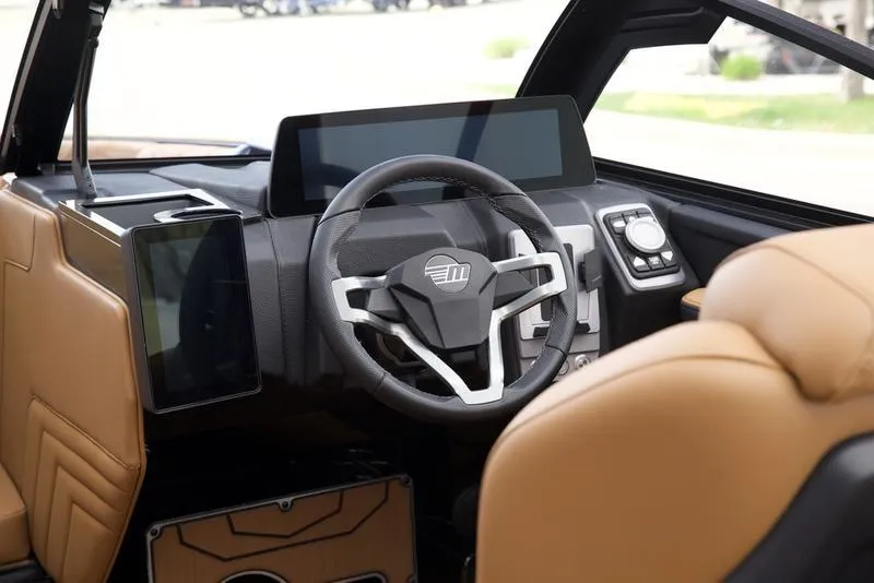 Slide: The Image of Interior of 2025 Malibu 25 LSV boat with modern steering and digital dashboard. - 12