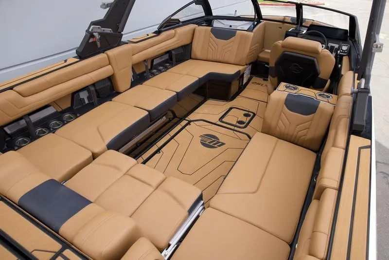 Slide: The Image of Luxurious interior of 2025 Malibu 25 LSV boat with tan leather seating and modern design. - 17