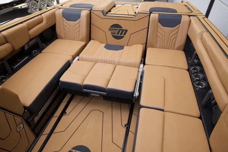 Slide: The Image of Luxurious interior of 2025 Malibu 25 LSV boat with tan and black seating. - 21