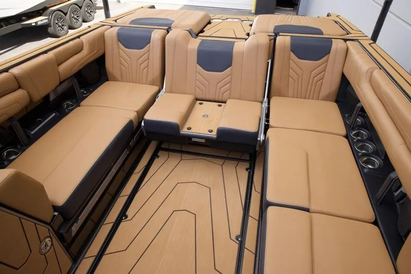Slide: The Image of Luxurious interior of 2025 Malibu 25 LSV boat with tan and black seating. - 22
