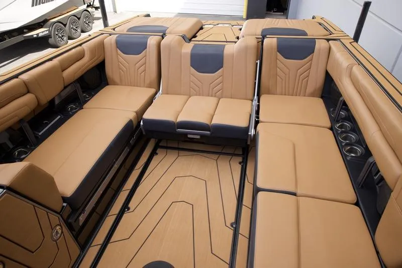 Slide: The Image of Luxurious interior of 2025 Malibu 25 LSV boat with tan and black seating. - 23
