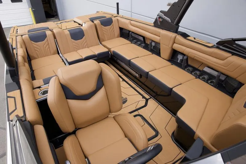 Slide: The Image of Luxurious interior of 2025 Malibu 25 LSV boat with tan and black seating. - 25