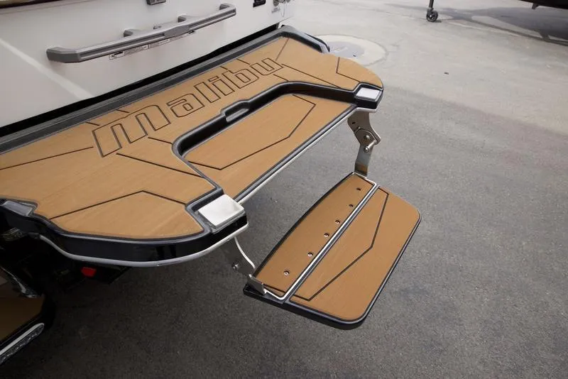 Slide: The Image of 2025 Malibu 25 LSV swim platform with foldable step, featuring sleek design and durable materials. - 6
