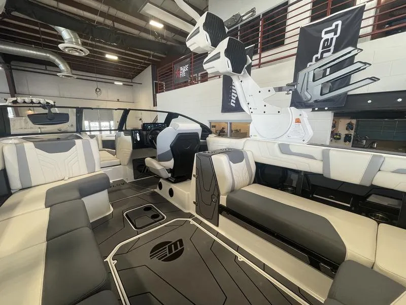 Slide: The Image of 2025 Malibu 25 LSV boat interior with modern seating and sleek design. - 12