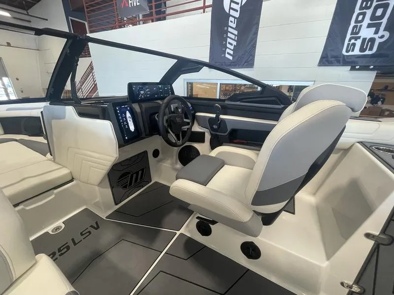 Slide: The Image of 2025 Malibu 25 LSV boat interior with modern dashboard and seating. - 14