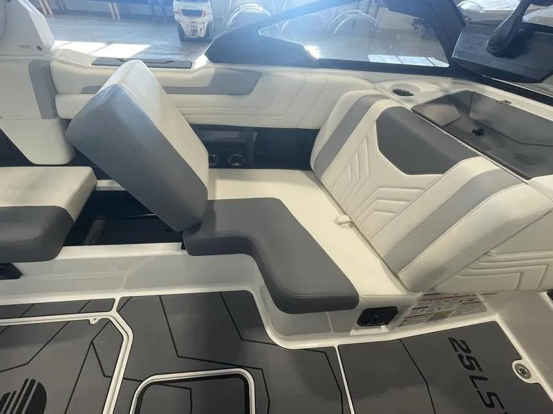 Slide: The Image of 2025 Malibu 25 LSV boat interior with gray and white seating and modern design. - 22