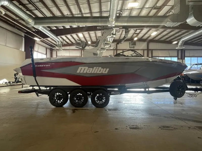 Slide: The Image of 2025 Malibu 25 LSV boat in warehouse, side view, on trailer. - 6