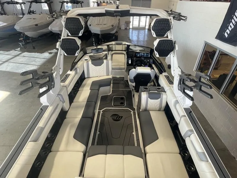 Slide: The Image of 2025 Malibu 25 LSV boat interior with spacious seating and modern design. - 9