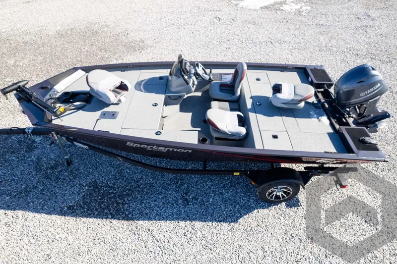 Slide: The Image of 2025 G3 Sportsman 1610 fishing boat with seating and motor, on gravel surface. - 10