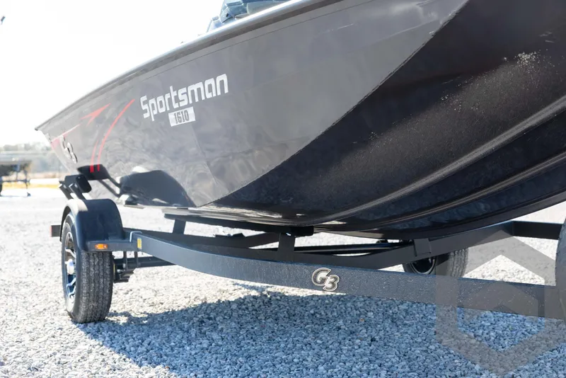 Slide: The Image of 2025 G3 Sportsman 1610 boat on trailer, side view, parked on gravel. - 11