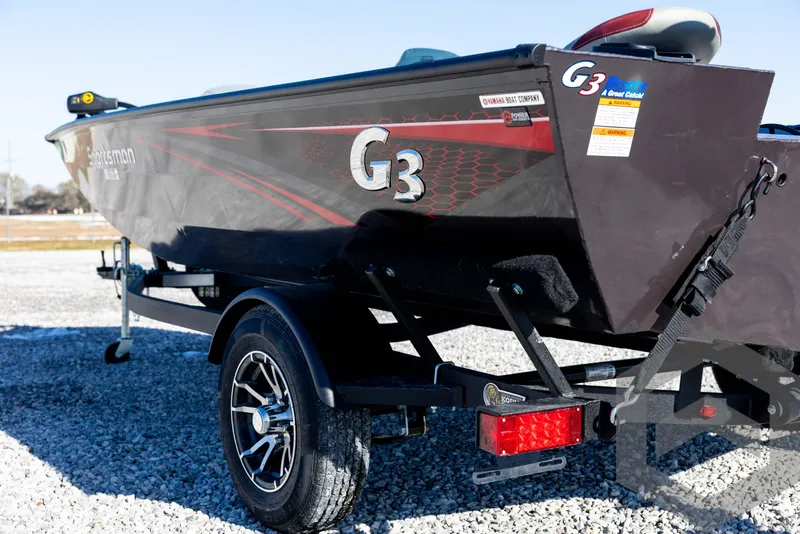Slide: The Image of 2025 G3 Sportsman 1610 boat on trailer, side view, parked on gravel. - 25