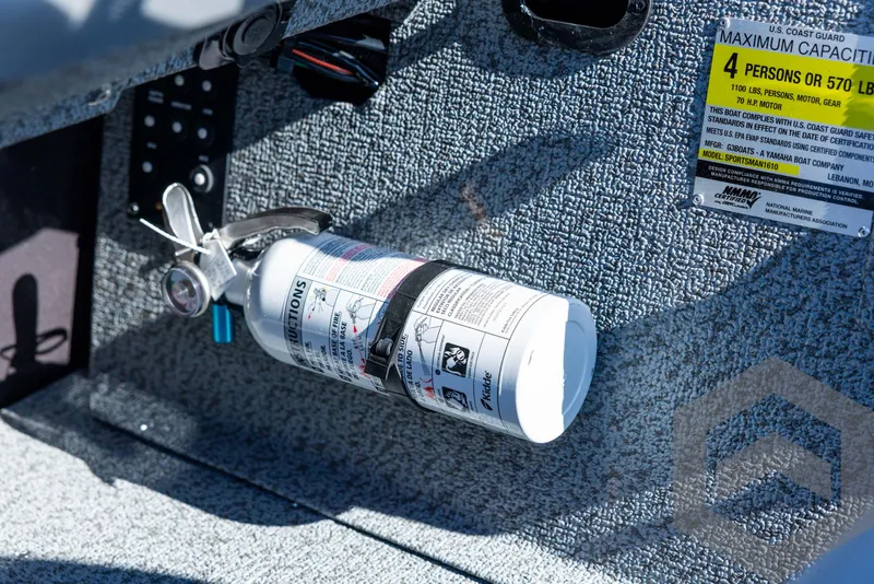 Slide: The Image of Fire extinguisher mounted on 2025 G3 Sportsman 1610 boat interior. - 48