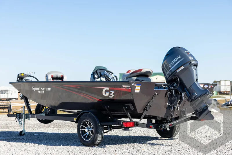 Slide: The Image of 2025 G3 Sportsman 1610 boat with Yamaha motor on trailer, parked on gravel. - 7