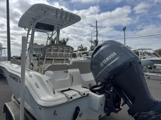 Slide: The Image of 2021 Key West 219fs boat with Yamaha outboard motor, parked outdoors. - 5