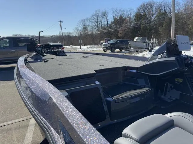 Slide: The Image of 2025 iKon VLX20 boat with spacious deck, parked outdoors on a sunny day. - 13