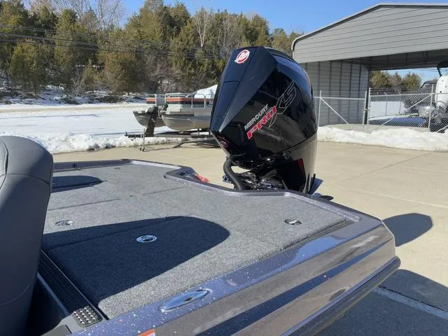 Slide: The Image of 2025 iKon VLX20 boat with powerful outboard motor, parked outdoors on a sunny day. - 14