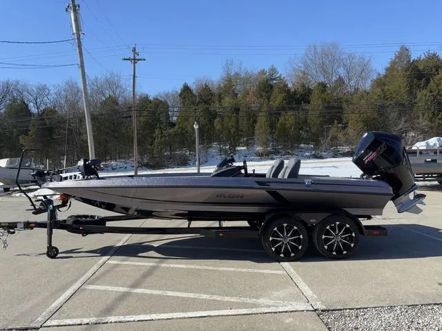 Slide: The Image of 2025 iKon VLX20 boat on trailer, parked outdoors, with trees in the background. - 15