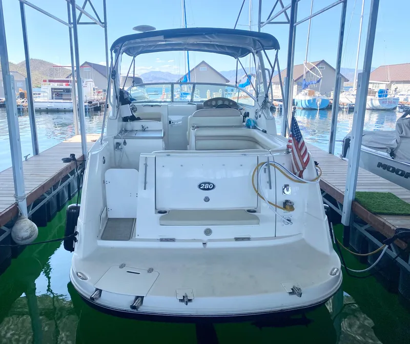 Slide: The Image of 2008 Rinker 280 Express Cruiser docked at marina, rear view. - 2