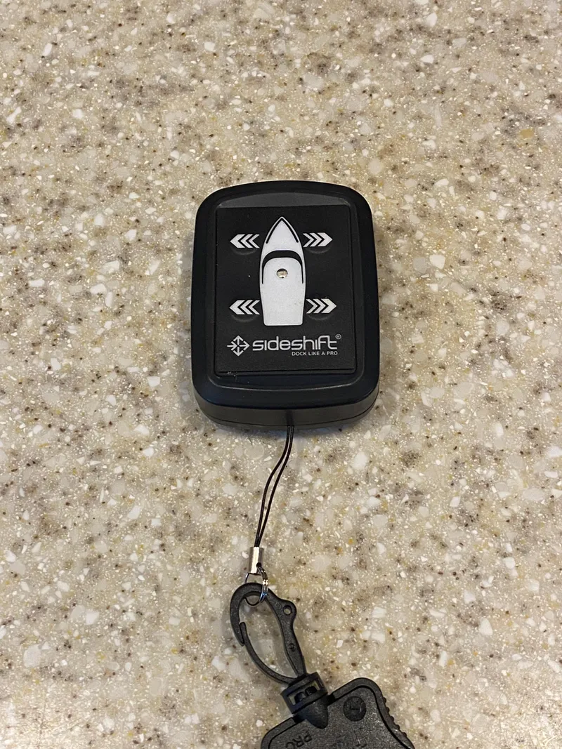 Slide: The Image of Remote control for 2008 Rinker 280 Express Cruiser on a speckled surface. - 23