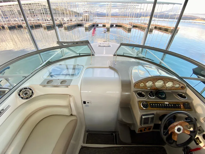 Slide: The Image of 2008 Rinker 280 Express Cruiser helm with scenic marina view. - 24