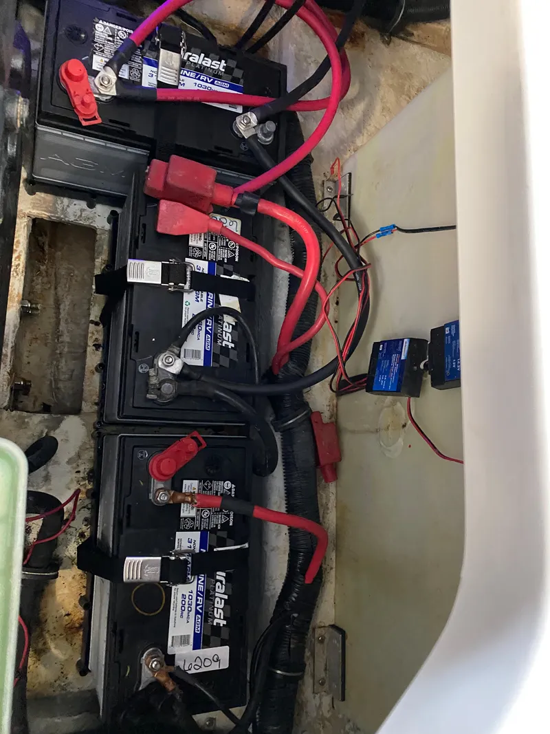 Slide: The Image of Battery compartment of a 2008 Rinker 280 Express Cruiser with multiple connected batteries. - 29