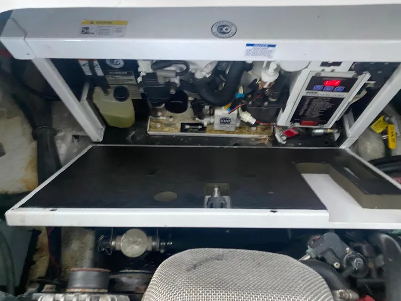 Slide: The Image of Engine compartment of a 2008 Rinker 280 Express Cruiser, showing mechanical components and wiring. - 32