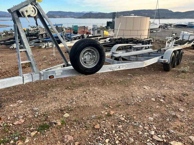 Slide: The Image of Boat trailer on rocky ground near a lake, suitable for 2008 Rinker 280 Express Cruiser. - 34