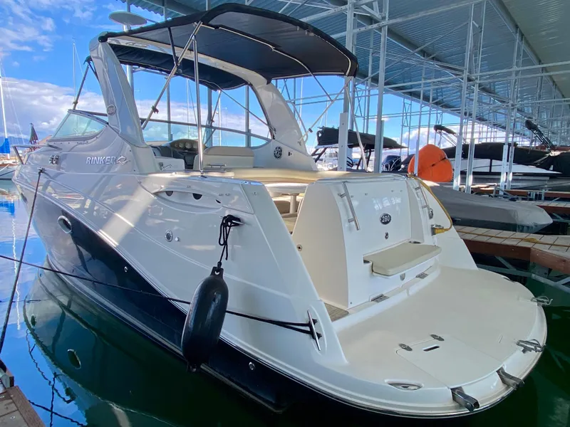 Slide: The Image of 2008 Rinker 280 Express Cruiser docked in a marina, featuring sleek design and spacious deck. - 35