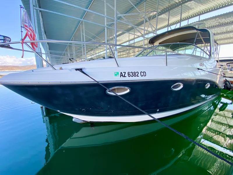 Slide: The Image of 2008 Rinker 280 Express Cruiser docked in marina, side view. - 36