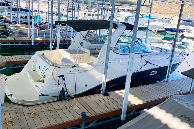 Slide: The Image of 2008 Rinker 280 Express Cruiser docked in a marina. - 42