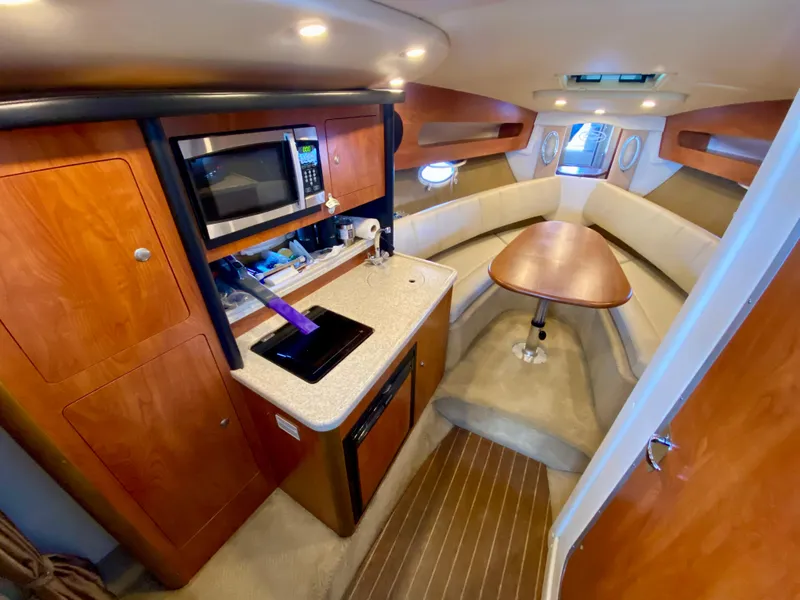 Slide: The Image of Interior of 2008 Rinker 280 Express Cruiser with kitchenette and seating area. - 47