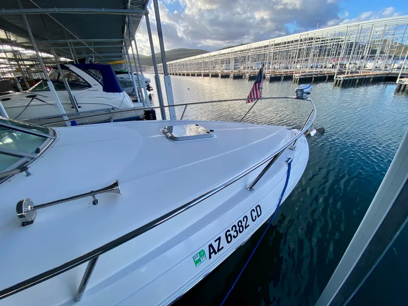 Slide: The Image of 2008 Rinker 280 Express Cruiser docked at marina, displaying registration AZ 6382 CD. - 5