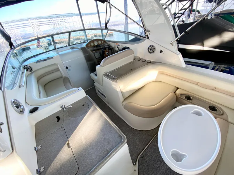 Slide: The Image of 2008 Rinker 280 Express Cruiser interior with helm, seating, and table. - 6