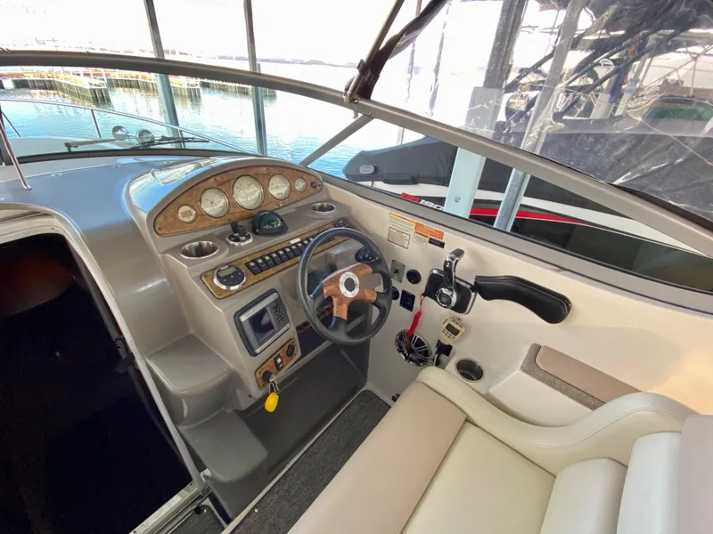 Slide: The Image of 2008 Rinker 280 Express Cruiser helm with steering wheel and control panel. - 8